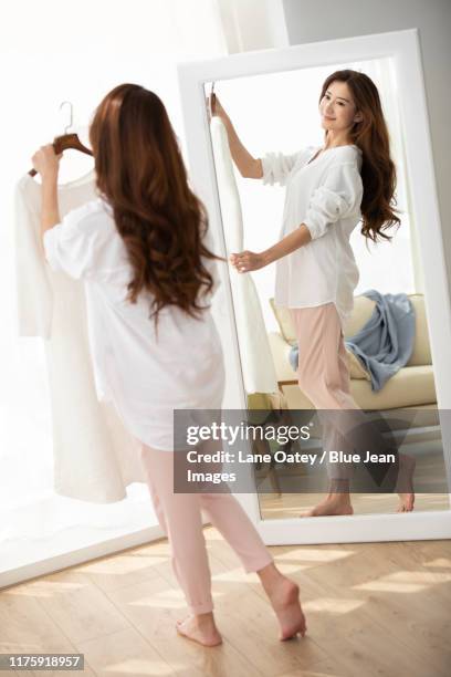 young woman dressing up at home - full length mirror fotografías e imágenes de stock