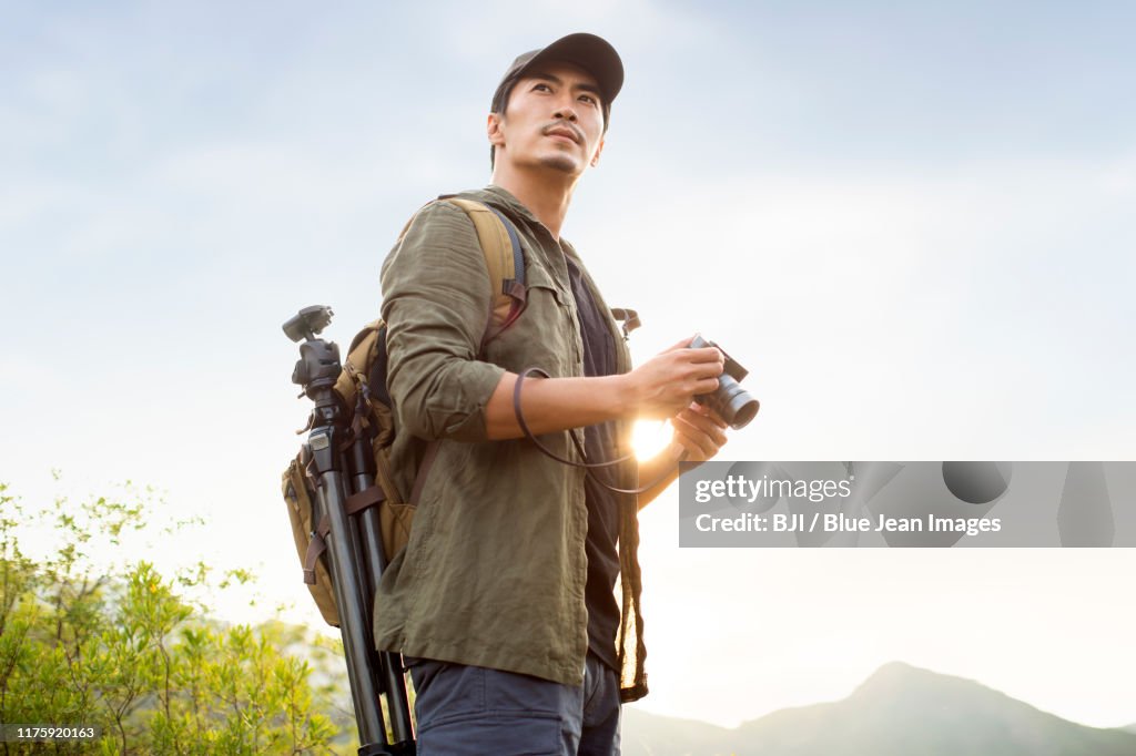 Chinese photographer taking photos outdoors