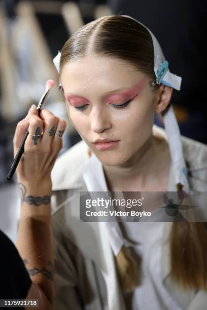 Model prepares backstage for Antonio Marras fashion show during the Milan Fashion Week Spring/Summer 2020 on September 20, 2019 in Milan, Italy.