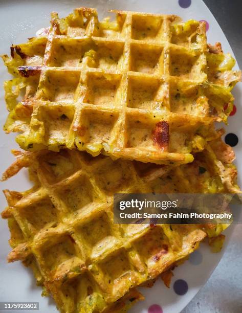 high angle view of salted waffles in plate - baked sweet potato stock-fotos und bilder