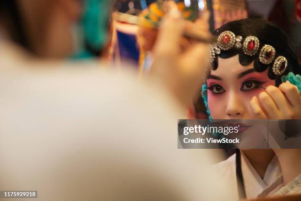female peking opera actor backstage makeup - chinese opera makeup stock pictures, royalty-free photos & images