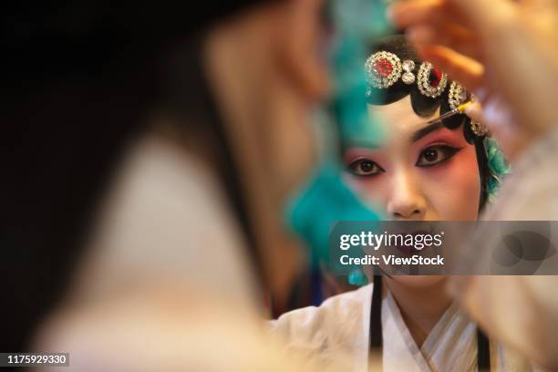 female peking opera actor backstage makeup - chinese opera makeup stock pictures, royalty-free photos & images