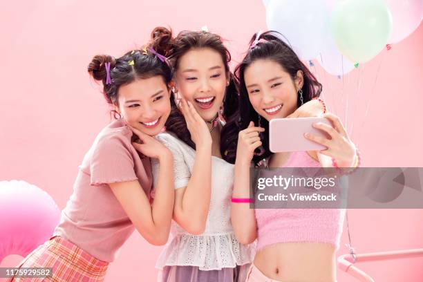 happy girl with mobile phones - east asian ethnicity fotografías e imágenes de stock
