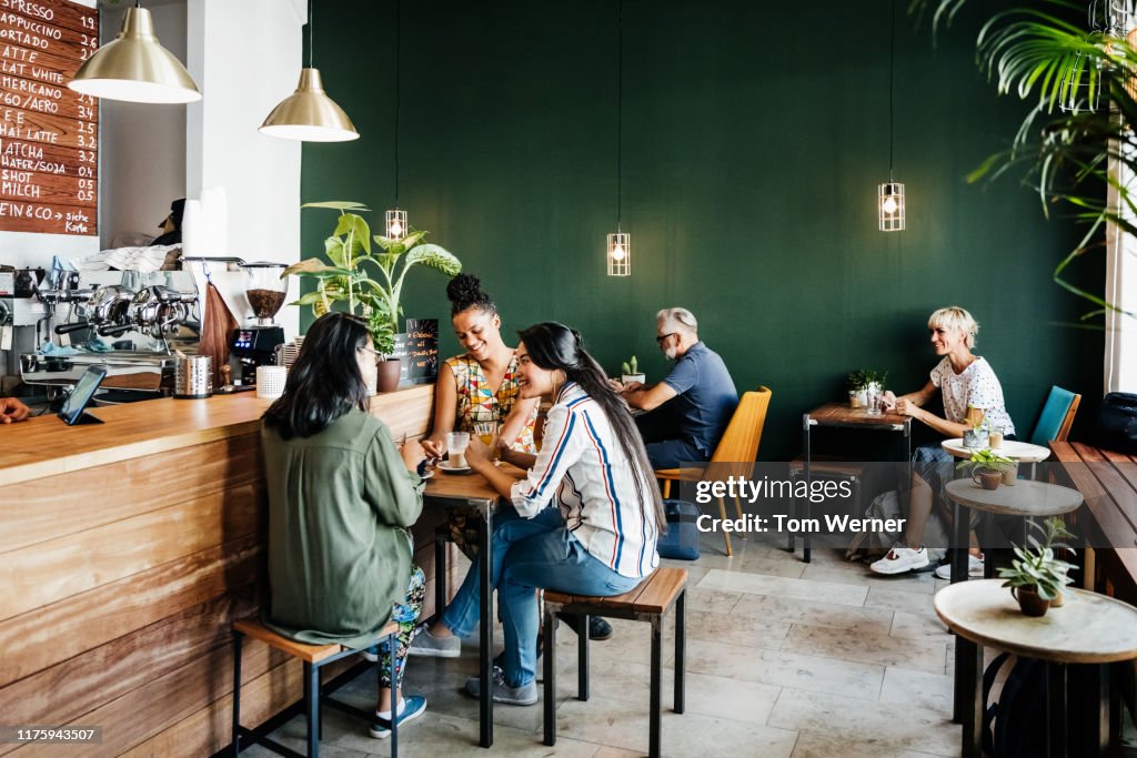 Busy Coffee Shop With Customers Sitting Down