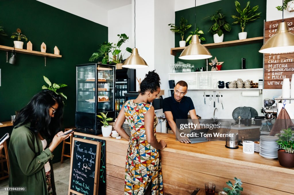 Queue Of People Waiting To Order At Coffee Shop