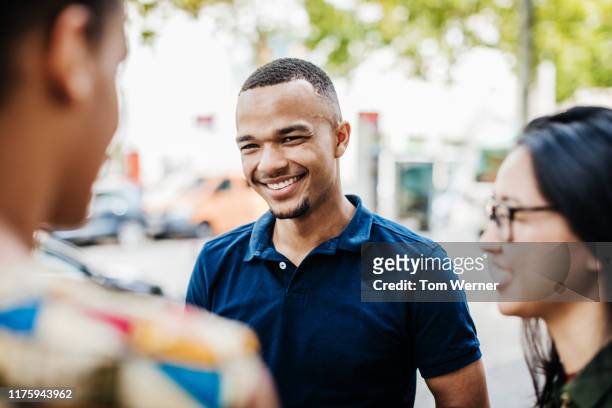 young man hanging out with friends in city - 3 men standing outside stock pictures, royalty-free photos & images