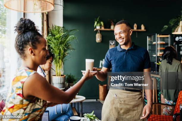 barista giving latte to customer in cafe - navy blue polo shirt stock pictures, royalty-free photos & images