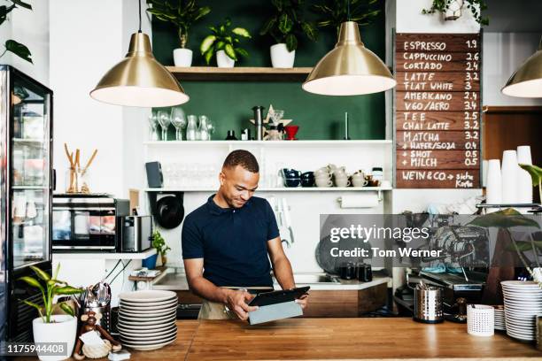 barista using tablet while working in cafe - waiter using digital tablet stock pictures, royalty-free photos & images