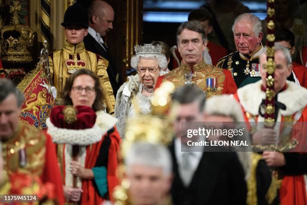 Britain's Queen Elizabeth II and Britain's Prince Charles, Prince of Wales proceed through the Royal Gallery to deliver the Queen's speech at the...