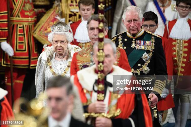 Britain's Queen Elizabeth II is accompanied by her son Britain's Prince Charles, Prince of Wales walk behind the Imperial State Crown as they...