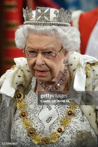 Britain's Queen Elizabeth II proceeds through the Royal Gallery during the State Opening of Parliament in the Houses of Parliament in London on...