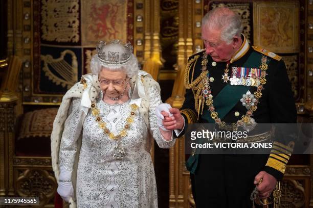 Britain's Queen Elizabeth II leaves with Britain's Prince Charles, Prince of Wales after delivering the Queen's Speech at the State Opening of...