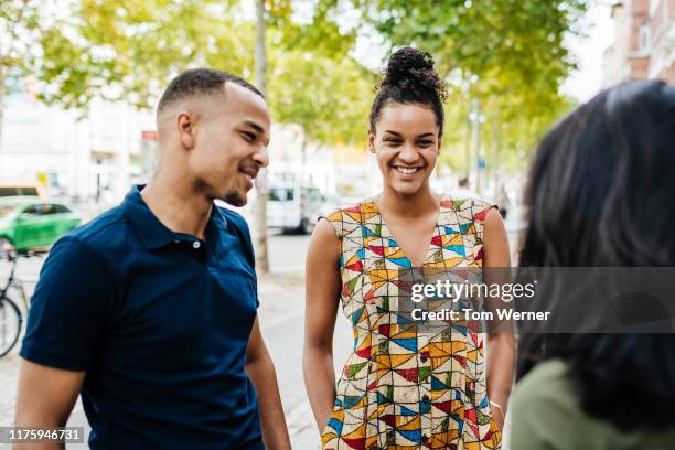 group of friends chatting outside cafe in the city - navy blue polo shirt stock pictures, royalty-free photos & images