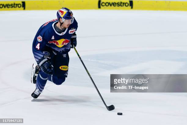 Blake Parlett of EHC Red Bull Muenchen controls the puck during the match between EHC Red Bull Muenchen and Iserlohn Roosters at Olympiaeishalle...