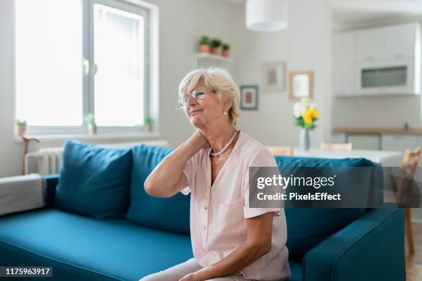 the pains that come with old age... - neckache stock pictures, royalty-free photos & images