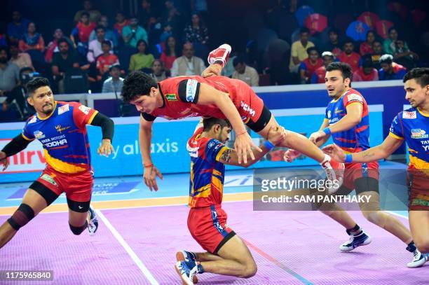 Sumit singh of Bengaluru Bulls jumps overs a UP Yoddha player during the Eliminator 1 of the Pro Kabaddi league match between the Bengaluru Bulls and...