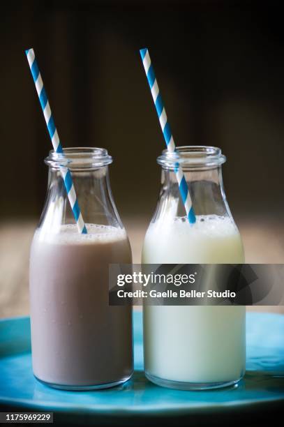 milk bottles with drinking straws - chocolate milk bottle stock pictures, royalty-free photos & images