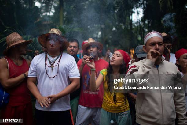 People smoke tobacco to ask María Lionza for her entrance to the mountain and to be able to pay her offering during a congregation of thousands of...