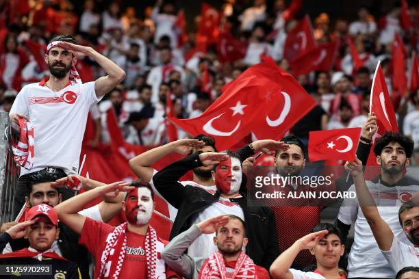 Turkish fans salute before the Euro 2020 Group H qualification football match between France and Turkey at the Stade de France in Saint-Denis,...