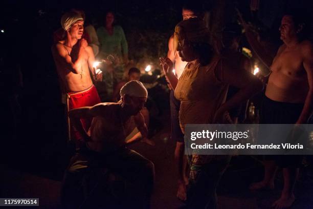 People following Maria Lionza go into a trance for different spirits at night during a spiritual ritual in a portal deep in the mountain of sorte on...