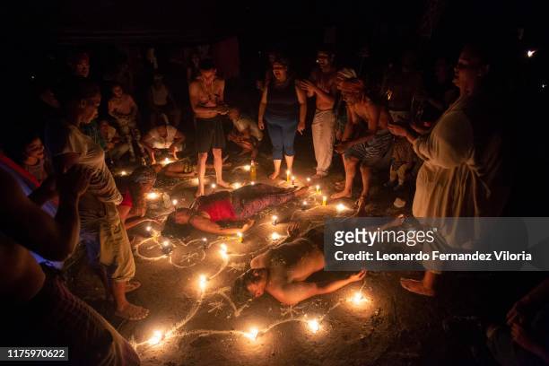 People participates in a healing ritual called "Velación" at night during a spiritual ritual in a portal in the mountain of Maria Lionza at Sorte on...
