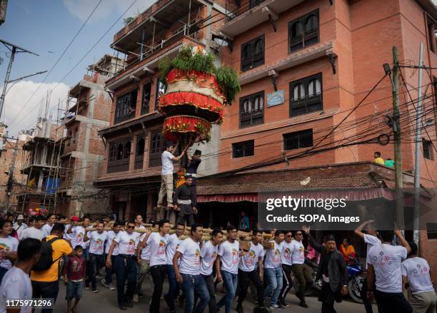 Locals carry the chariot of Lord Narayan during the festival. The Narayan Jatra Festival of Hadigaun is a unique festival in which the idol of the...