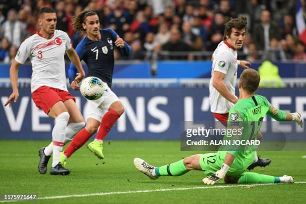 Turkey's goalkeeper Mert Gunok clears the ball past Turkey's defender Merih Demiral and France's forward Antoine Griezmann during the Euro 2020 Group...
