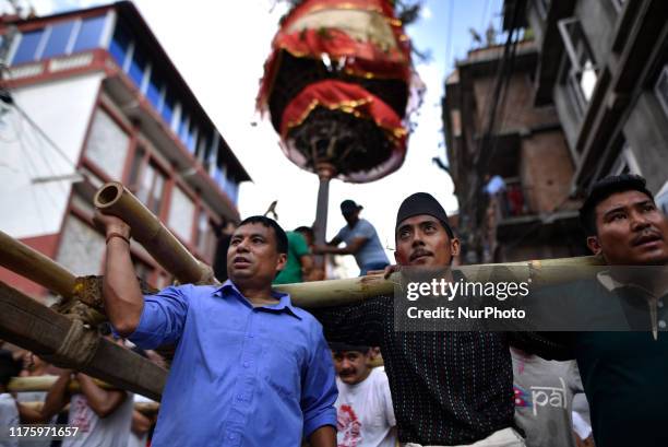 Locals carry as well as rotates top part of a chariot of Lord Narayan across the streets of Hadigaun during Lord Narayan jatra festival in Hadigaun,...