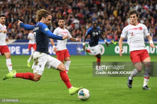 France's forward Antoine Griezmann kicks the ball past Turkey's defender Caglar Soyuncu during the Euro 2020 Group H qualification football match...