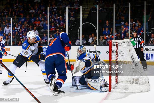 Anders Lee of the New York Islanders watches as a shot from teammate Mathew Barzal goes past Jordan Binnington the St. Louis Blues for the game-tying...
