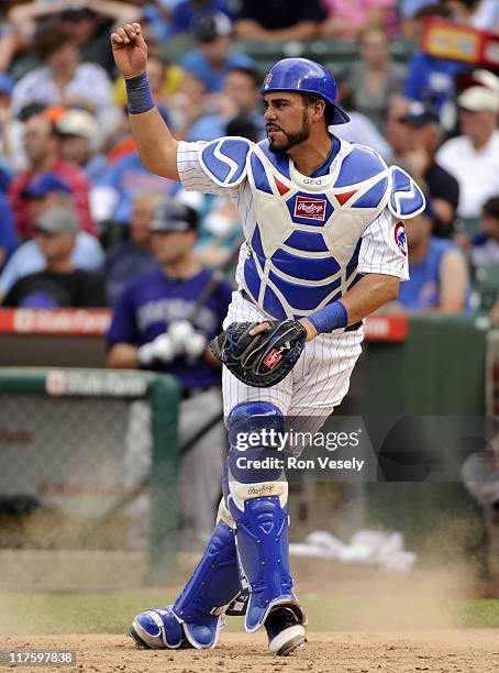 Geovany Soto of the Chicago Cubs follows through after making a throw to second base during the game against the Colorado Rockies on June 27, 2011 at...