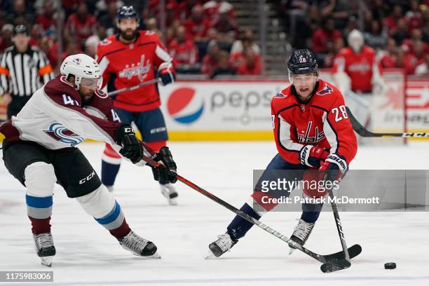 Brendan Leipsic of the Washington Capitals and Pierre-Edouard Bellemare of the Colorado Avalanche battle for the puck in the first period at Capital...