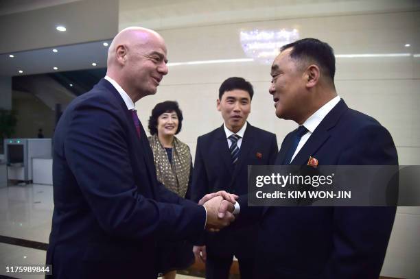 President Gianni Infantino shakes hands with Kim Jang San , secretary general of North Korean Football Association, upon his arrival at Pyongyang...