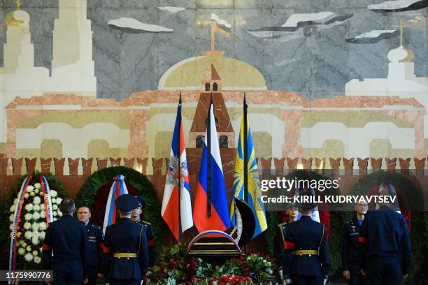 Russian honour guards surround the coffin of late Soviet cosmonaut Alexei Leonov during a farewell ceremony at a military cemetery in Mytishchi,...