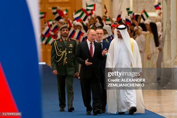 Russian President Vladimir Putin and Abu Dhabi Crown Prince Mohammed bin Zayed al-Nahyan attend the official welcome ceremony in Abu Dhabi, United...