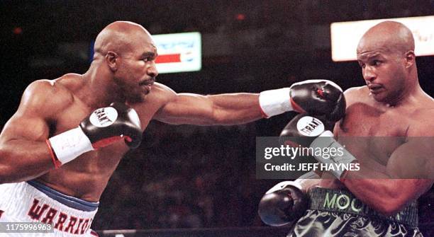 Evander Holyfield punches Michael Moorer in the first round of their WBA/IBF Heavyweight Championship Unification fight 08 November at the Thomas &...