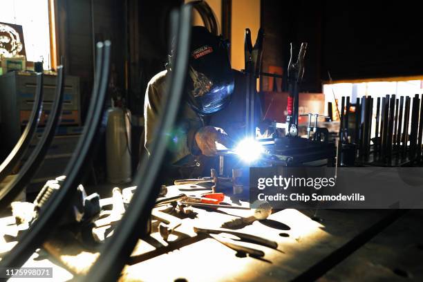 Hellgate Forge Fabricator and Welder Troy Bloom welds handmade fixtures at the company's shop inside the former lumber mill's 100-year-old machine...