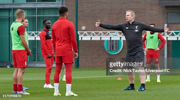 Coach Thomas Gronnemark speaks to the players of Liverpool during a training session at Melwood Training Ground on October 15, 2019 in Liverpool,...