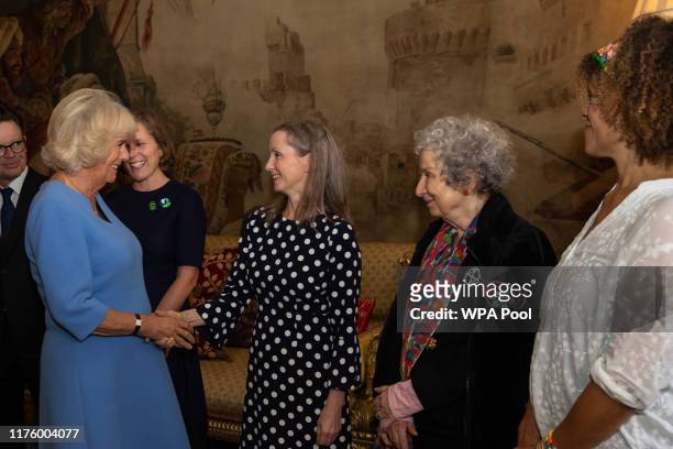Camilla, Duchess of Cornwall shakes hands with 2018 Booker prize winner Anna Burns next to 2019 Booker prize winners Margaret Atwood and Bernardine...