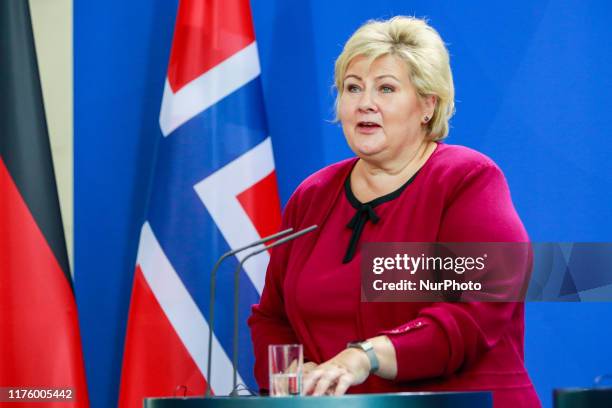 Prime Minister of Norway Erna Solberg reacts while speaking to the media with German Chancellor Angela Merke after their meeting at the chancellory...
