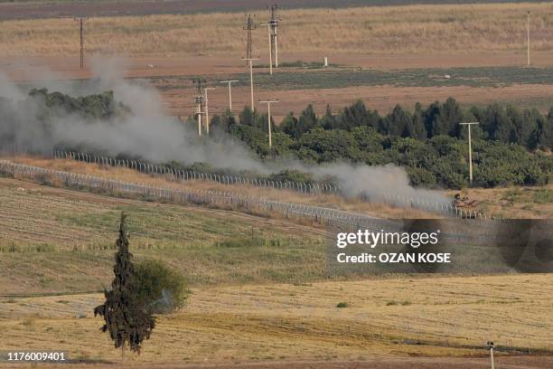 This picture taken on October 15, 2019 shows a Turkish army tank driving on a field at the border town Ceylanpinar in Sanliurfa near the Syrian town...