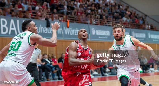 Bonzie Colson II of Darussafaka Istanbul, Cameron Wells of s.Oliver Wuerzburg and Dogus Oezdemiro of Darussafaka Istanbul battle for the ball during...