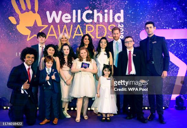Prince Harry, Duke of Sussex and Meghan, Duchess of Sussex pose for a group photograph with award winners and presenters during the WellChild Awards...