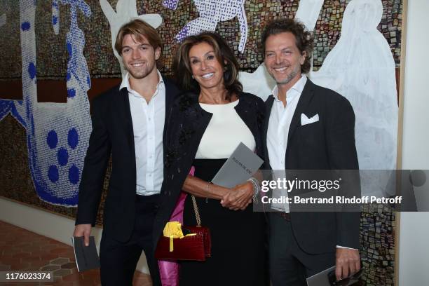 Myriam Laffont standing between Alessandro Vedovi and his father Paolo Vedovi attend the Kering Heritage Days opening night at Kering and Balenciaga...