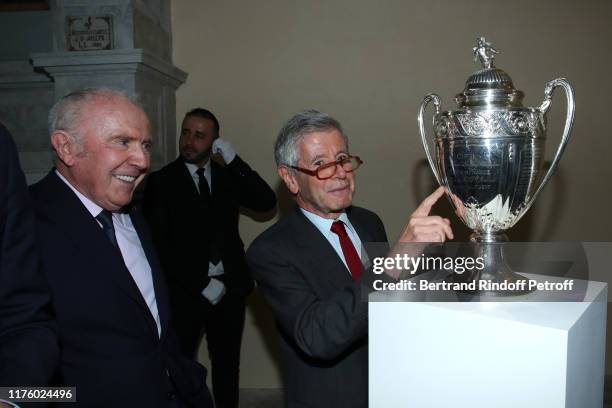 Owner of the "Stade Rennais" Football Club, Francois Pinault and Alain Minc pose with the French Football Cup 2019 won by the "Stade Rennais" during...