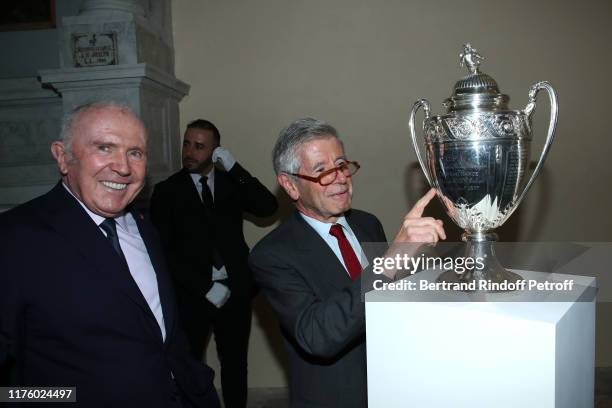 Owner of the "Stade Rennais" Football Club, Francois Pinault and Alain Minc pose with the French Football Cup 2019 won by the "Stade Rennais" during...