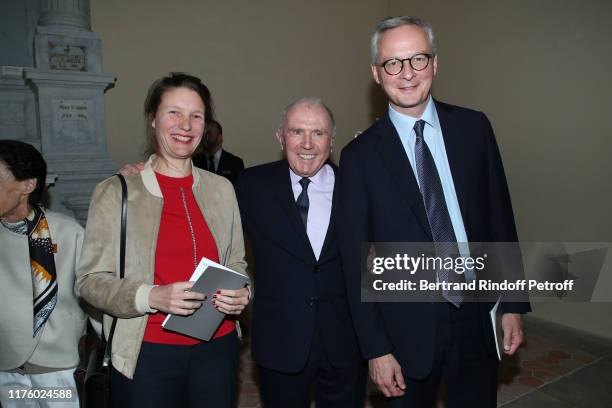 Francois Pinault standing between Politician Bruno Le Maire and his wife Pauline Doussau de Bazignan attend the Kering Heritage Days opening night at...