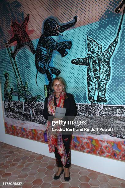 Rosalie Varda poses int front of the work of artist Sigmar Polke, "Zirkusfiguren", during the Kering Heritage Days opening night at Kering and...