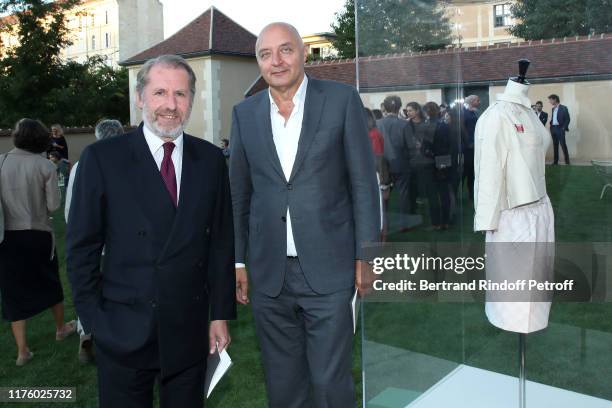 Guillaume de Seynes and Pascal Morand pose near a sewing pattern of Balenciga dresses during the Kering Heritage Days opening night at Kering and...