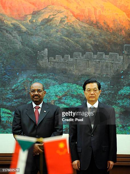 President Of Sudan Omar al-Bashir and Chinese President Hu Jintao attend the signing ceremony at the Great Hall of the People on June 29, 2011 in...